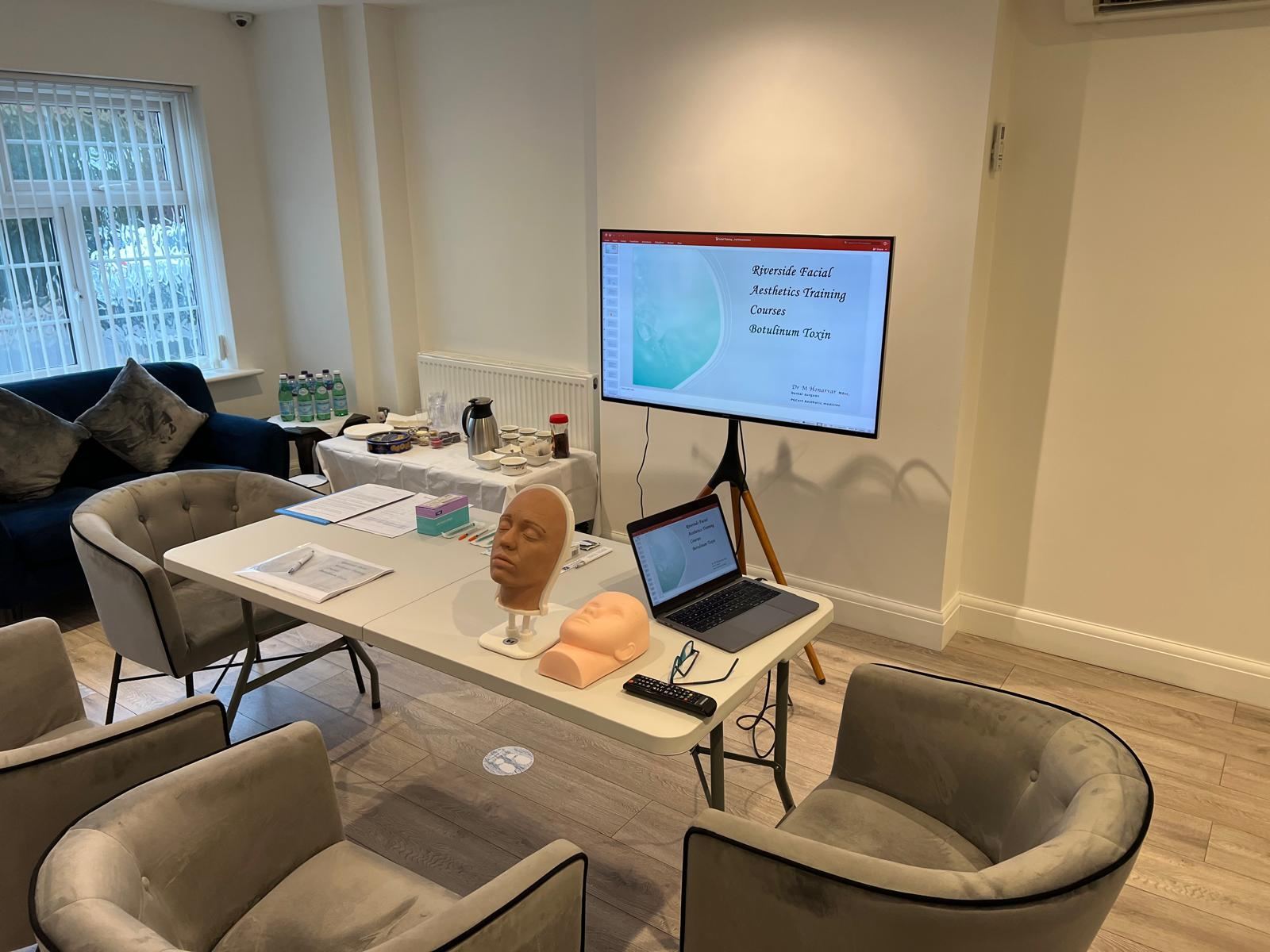 Training classroom with presentation screen and facial models